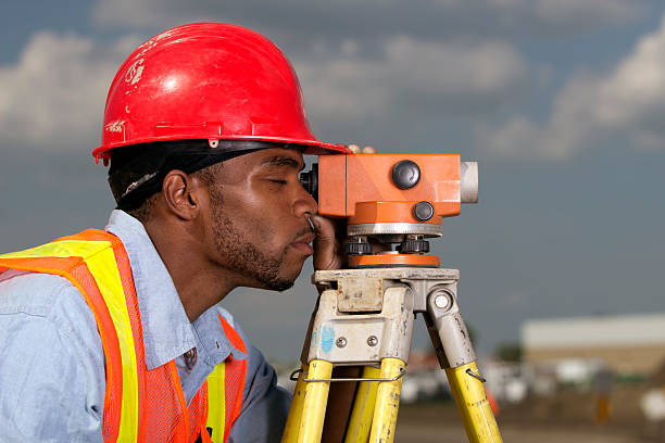 A royalty free image from the construction industry of a surveyor at a construction site