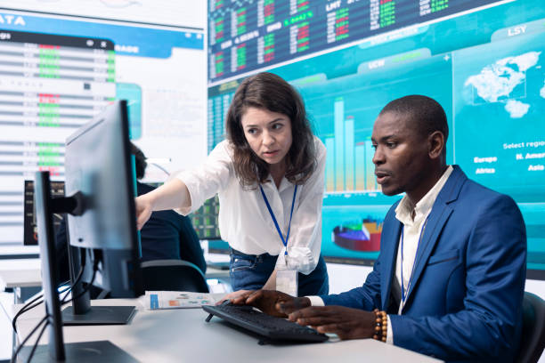 Business associates evaluating key performance indicators within the company, conducting evaluations and discussing workflow situation. Workers enhancing productivity and efficiency.